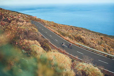 EVOC cyclists riding coastal road in La Palma