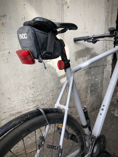 EVOC seatbag with tail light attached affixed under bike saddle