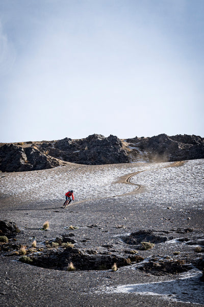 Mountain biker leaving track on a hail covered slope